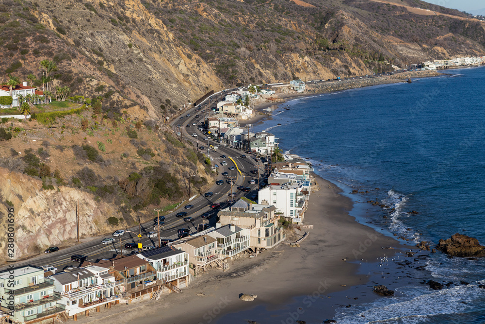 Aerial of beach homes along curving section of Pacific Coast Highway near Los Angeles and Malibu in Southern California.  