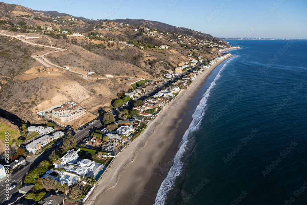 Aerial of shoreline homes and buildings near of Los Angeles and Santa Monica on Highway 1 in Malibu, California.  