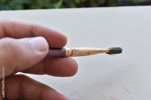 woman hand holding painting brush