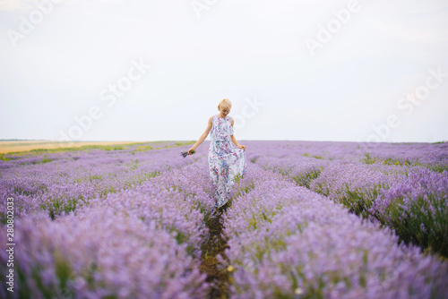A  young woman in the middle of lavender field.