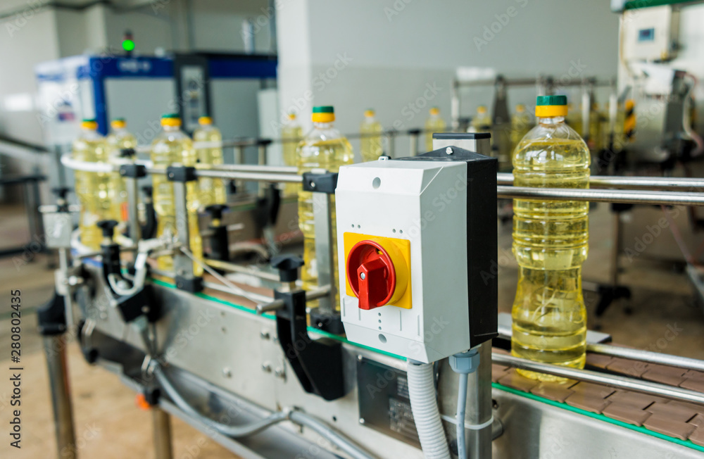 Bottling line of sunflower oil in bottles. Vegetable oil production plant. High technology. Bottling line of sunflower oil in bottles. Vegetable oil production plant. High technology.