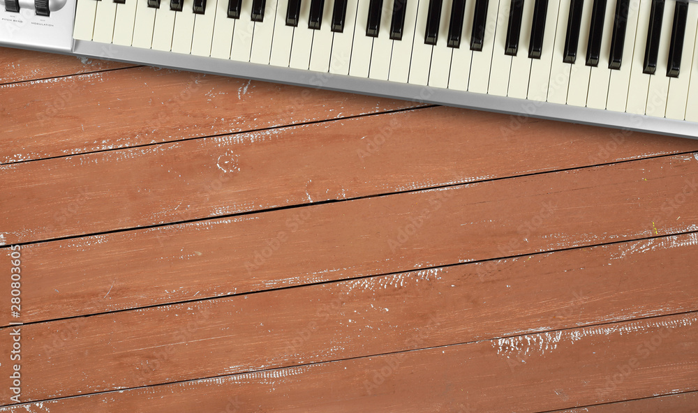 Musical instrument - Fragment grey MIDI keyboard wood background Musical instrument - Fragment grey MIDI keyboard wood background