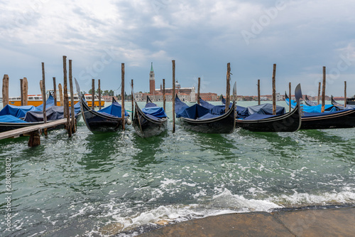 some gondolas of Venice are next to each other in the water