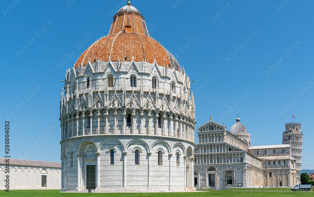 the Leaning Tower of Pisa and the Cathedral of Pisa in front of a bright blue sky