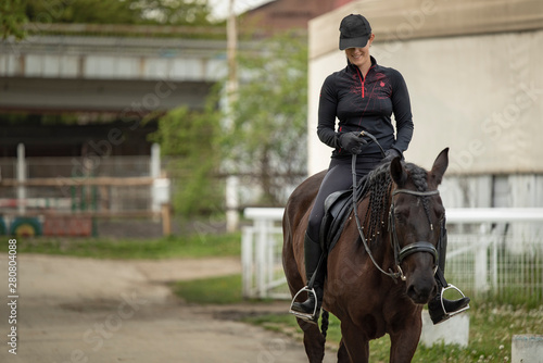 Young jockey woman horsebacking