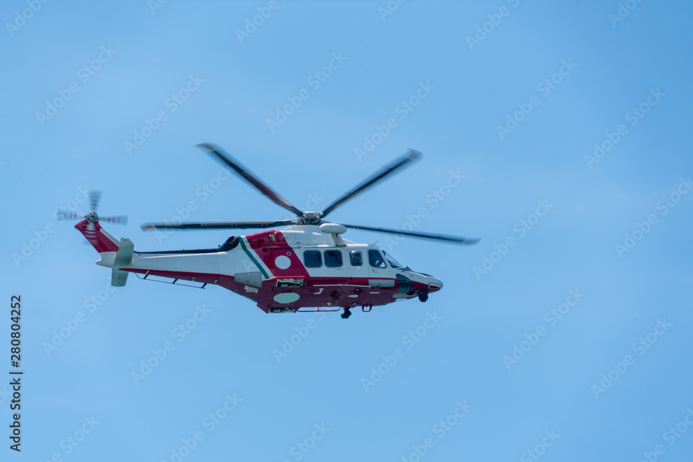 a helicopter flies in the blue sky a helicopter flies in the blue sky