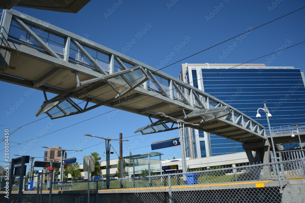 Pedestrian bridge over train track line at city station. Pedestrian bridge over train track line at city station.