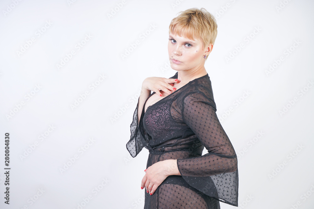 Φωτογραφία Beautiful woman in trendy chiffon black transparent dress on white studio backgr