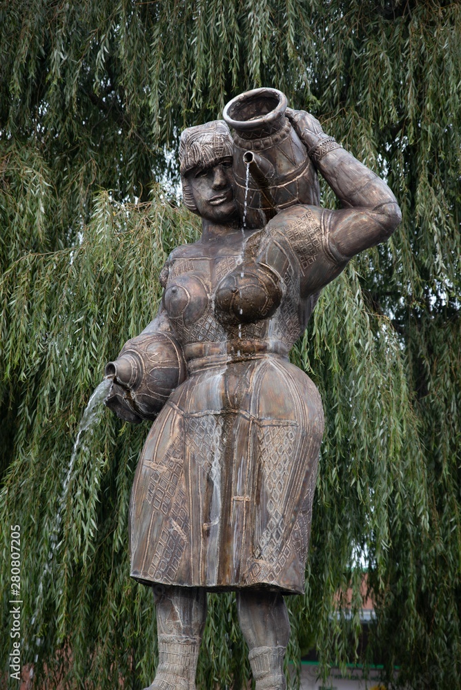 Statue of a woman carrying water