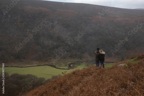 Couple looking at a green scenery in Ireland