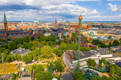 Aerial view of the Tivoli Gardens amusement park with people, visitors, attractions and rides. Urban view of the city of Copenhagen in Denmark, Europe photo