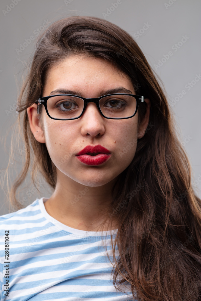 Thoughtful studious young woman wearing glasses Thoughtful studious young woman wearing glasses