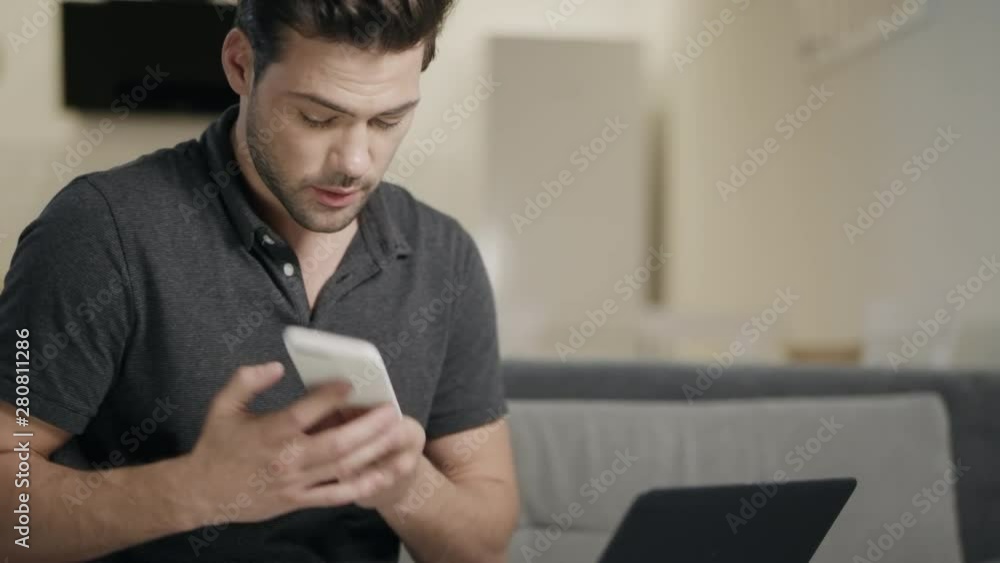 Concentrated man working at home in day time. Business man talking phone at home Concentrated man working at home in day time. Business man talking phone at home