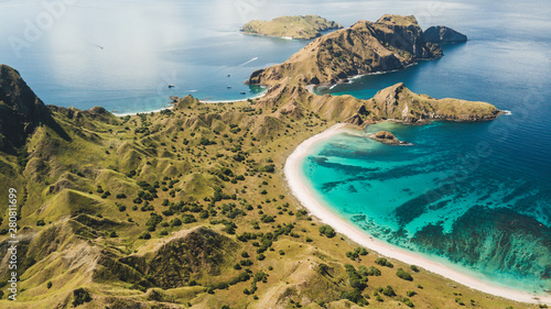 Aerial panoramic view of Padar island in Komodo National Park, Indonesia. Drone shot, top view. Green hills and amazing beautiful coastline. Tropical background. photo