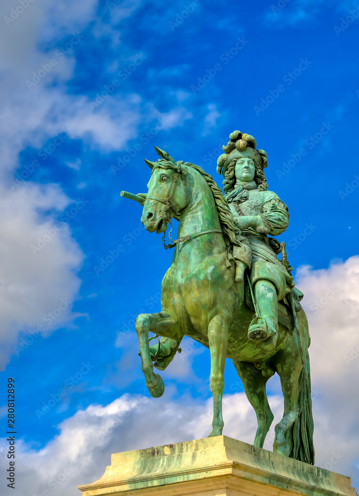 Versailles, France - April 24, 2019: Louis XIV statue just outside of the gates of Versailles Palace on a sunny day outside of Paris, France.