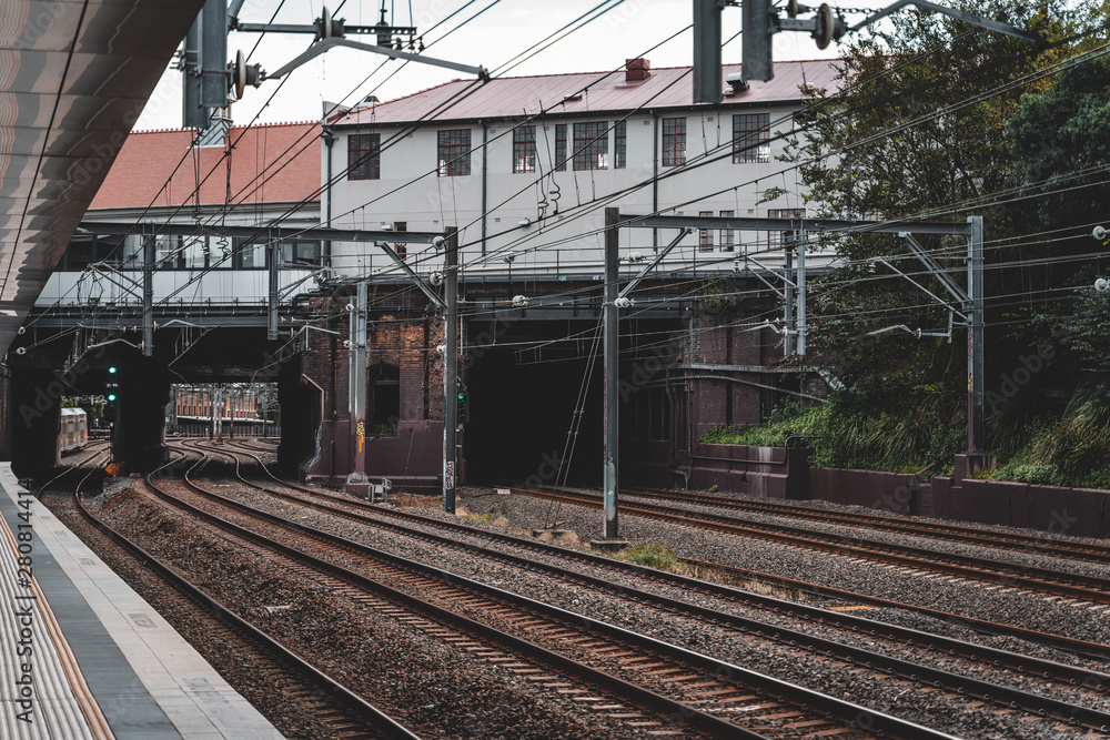 Newtown, New South Wales - JUNE 23rd, 2019: Waiting for the train on a cloudy day at Newtown Station. Newtown, New South Wales - JUNE 23rd, 2019: Waiting for the train on a cloudy day at Newtown Station.