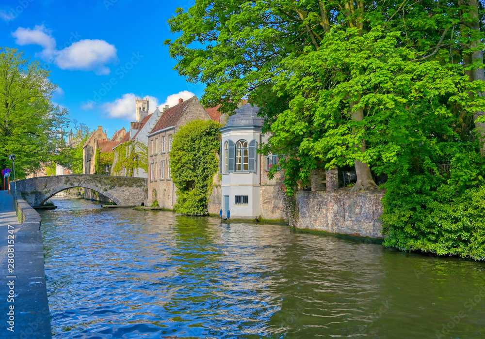 The canals of Bruges (Brugge), Belgium on a sunny day. The canals of Bruges (Brugge), Belgium on a sunny day.