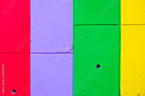 Colorful stripes painted on the wall, vertical and horizontal, in bold saturated colors.