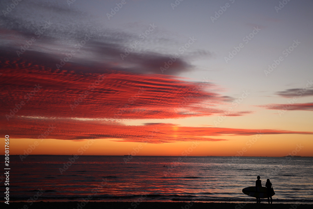 Vibrant Red Melbourne Sunset with Stand Up Paddleboarder at Port Philip Bay from St Kilda Beach