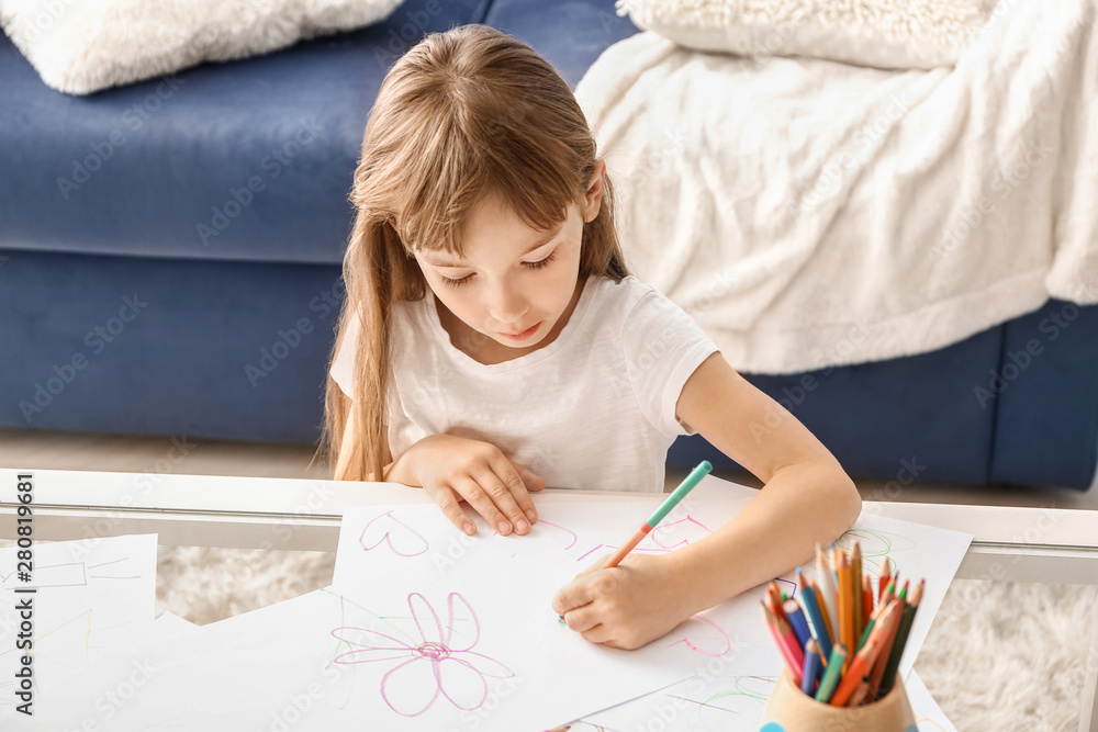 Cute little girl drawing at home