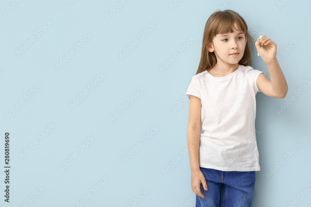 Little girl with crayon near color wall Little girl with crayon near color wall