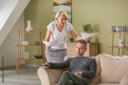 Angry wife scolding her hus...