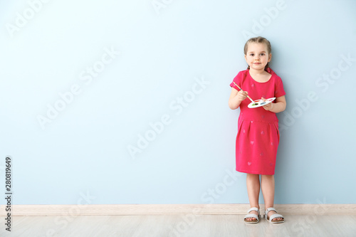 Little girl with brush and ...