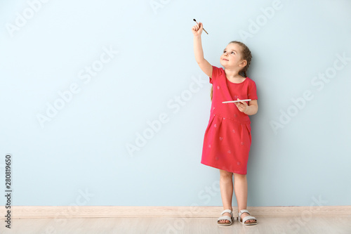 Little girl with brush and ...