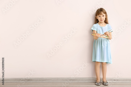 Wallpaper Mural Little girl with brush and palette near light wall Torontodigital.ca