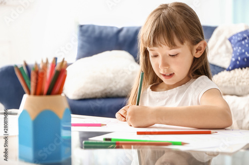 Cute little girl drawing at...