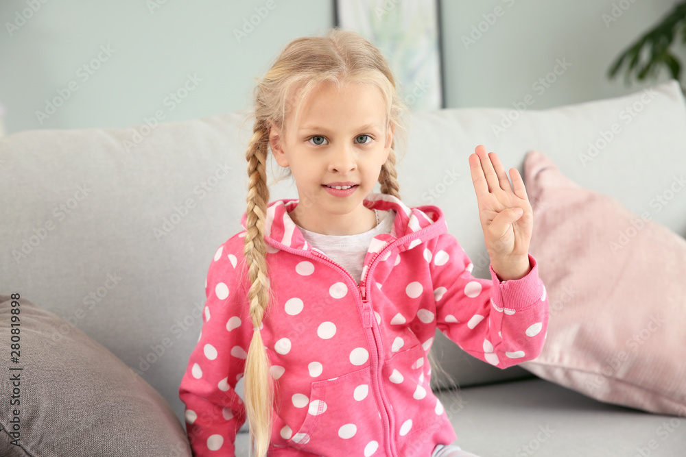 Little deaf mute girl using sign language at home Little deaf mute girl using sign language at home