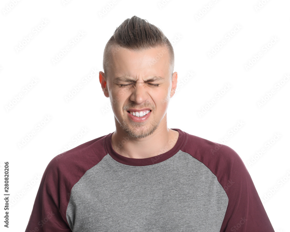 Fototapeta premium Young man with closed eyes on white background