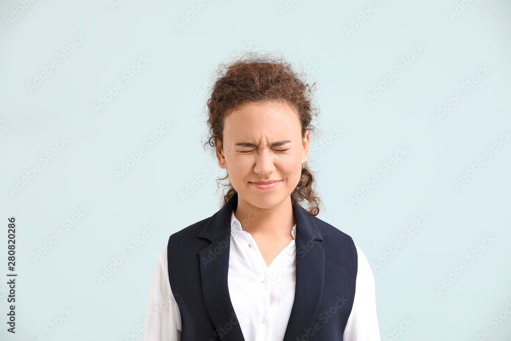 Young African-American woman with closed eyes on light background Young African-American woman with closed eyes on light background
