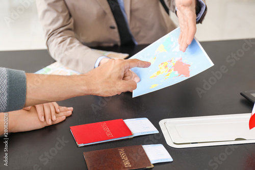 Male travel agent working w...
