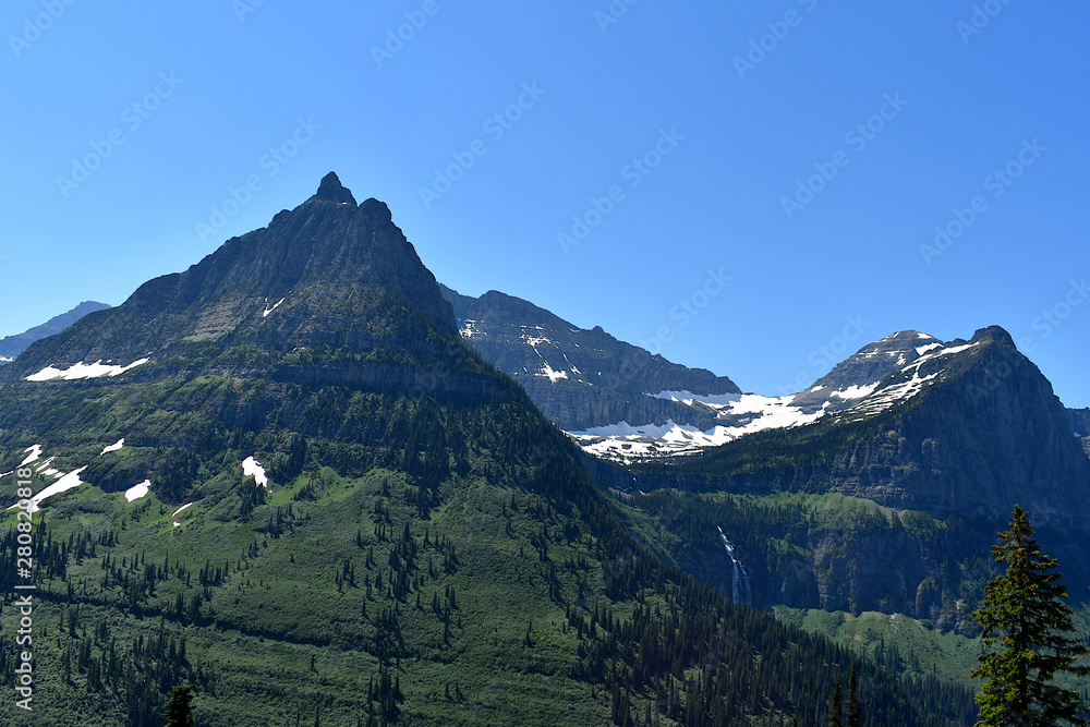 Green and Snow Dusted Mountain Range with Hidden Waterfall, Going-to-the-Sun Road, Glacier National Park, Montana	