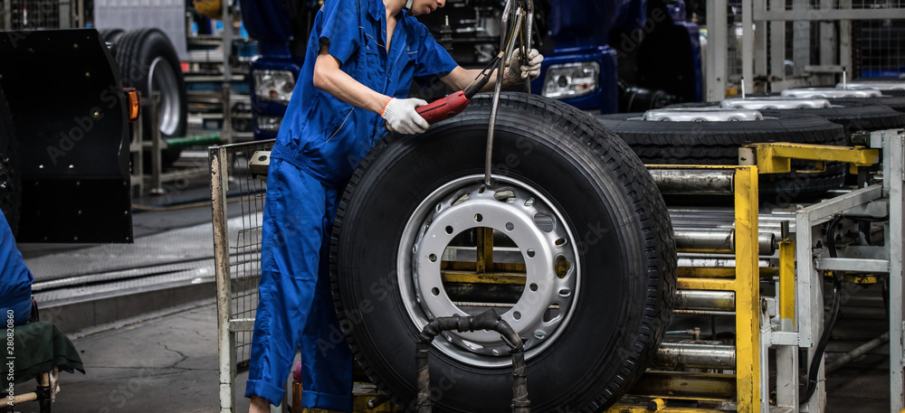 Fototapeta premium Workers in machinery factory in China.