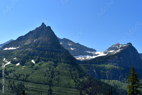 Green and Snow Dusted Mountain Range with Hidden Waterfall, Going-to-the-Sun Road, Glacier National Park, Montana 