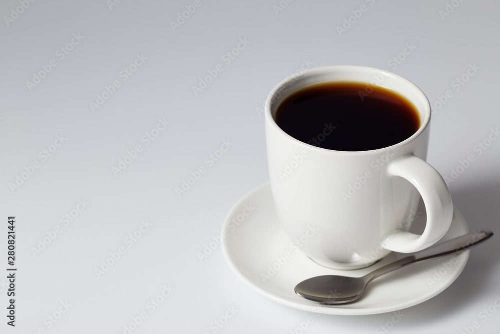 cup of coffee on bright gray background