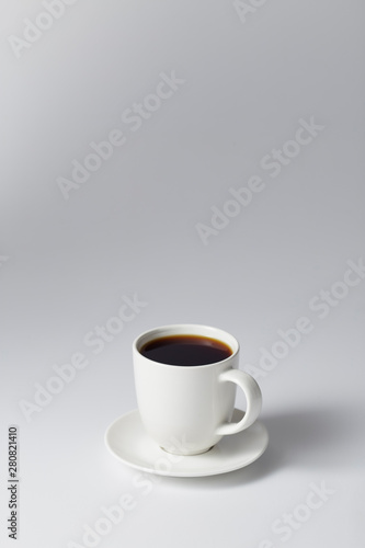 cup of coffee on bright gray background