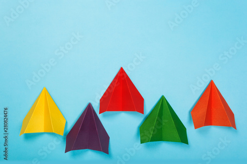 Color paper airplanes on blue background. Different vision creative and Innovative solution for Business concepts. © Nana_studio