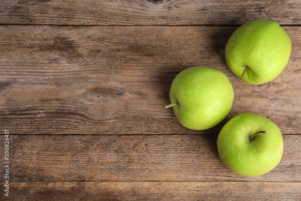 Flat lay composition of fresh ripe green apples on wooden table, space for text Flat lay composition of fresh ripe green apples on wooden table, space for text