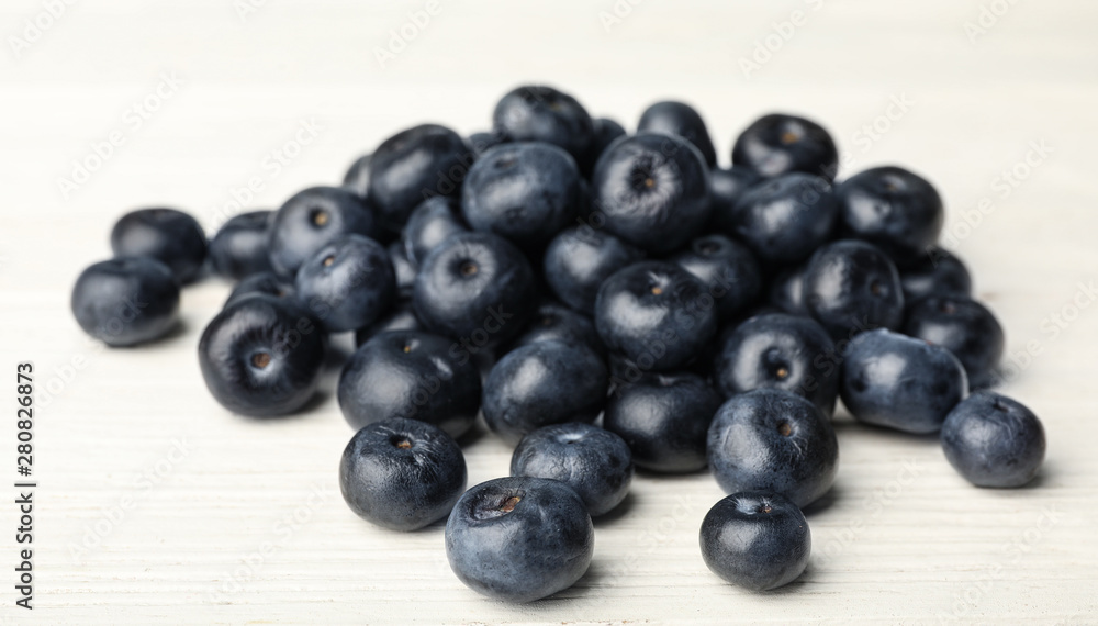 Fresh acai berries on white wooden table, closeup view Fresh acai berries on white wooden table, closeup view