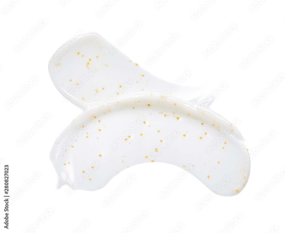 Smears and texture of white face cream with yellow peas on a white background Smears and texture of white face cream with yellow peas on a white background