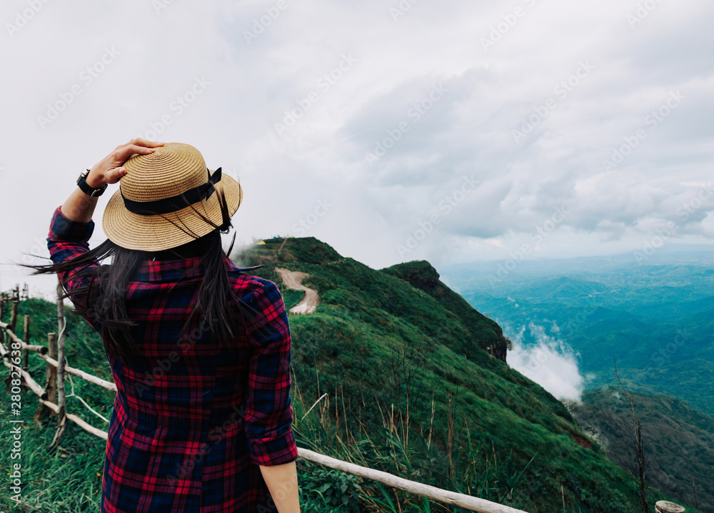 Woman travel rainy season mountain view relax in the holiday