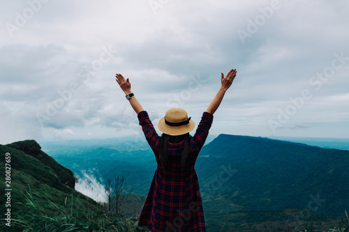 Woman travel rainy season mountain view relax in the holiday
