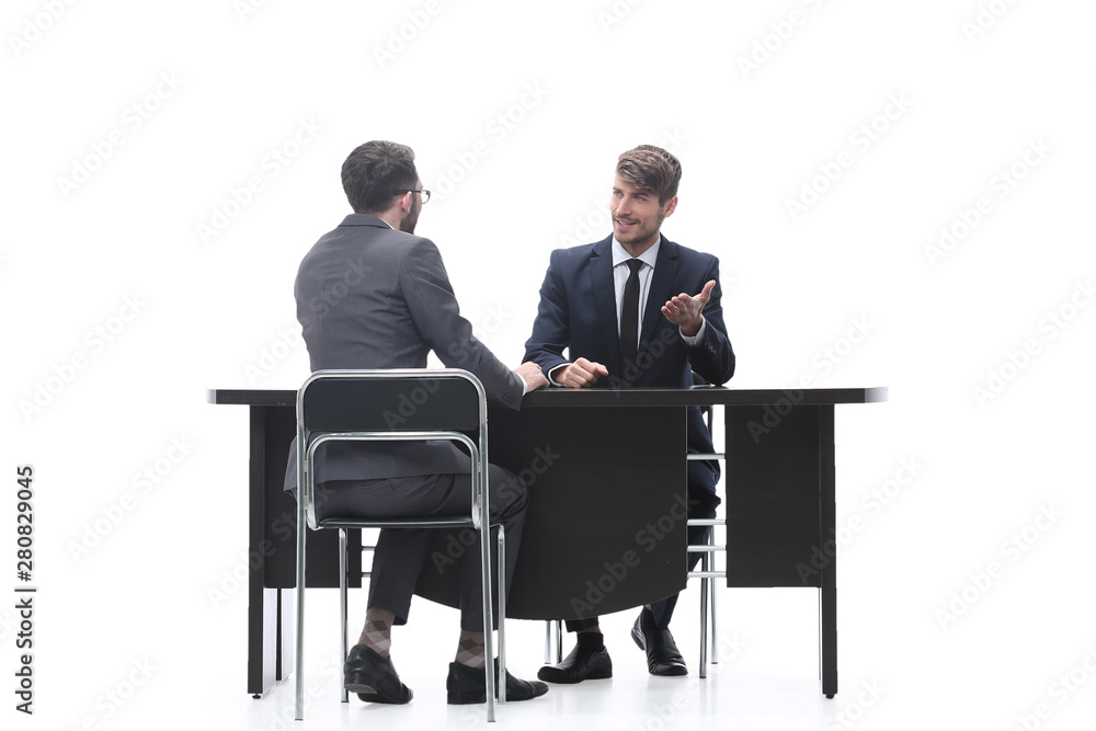 two business people talking sitting at a Desk two business people talking sitting at a Desk