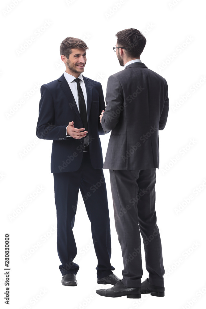 in full growth. two young businessmen discussing something in full growth. two young businessmen discussing something