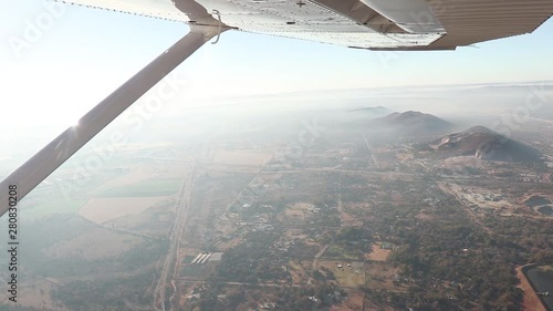 Wide Shot From Passenger Seat of Plane; View of Wing Overlooking Mountains and Morning Landscape photo