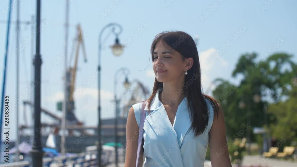 Beautiful girl strolling and enjoying her life on the Dnipro quay with lamps in slo-mo Beautiful girl strolling and enjoying her life on the Dnipro quay with lamps in slo-mo