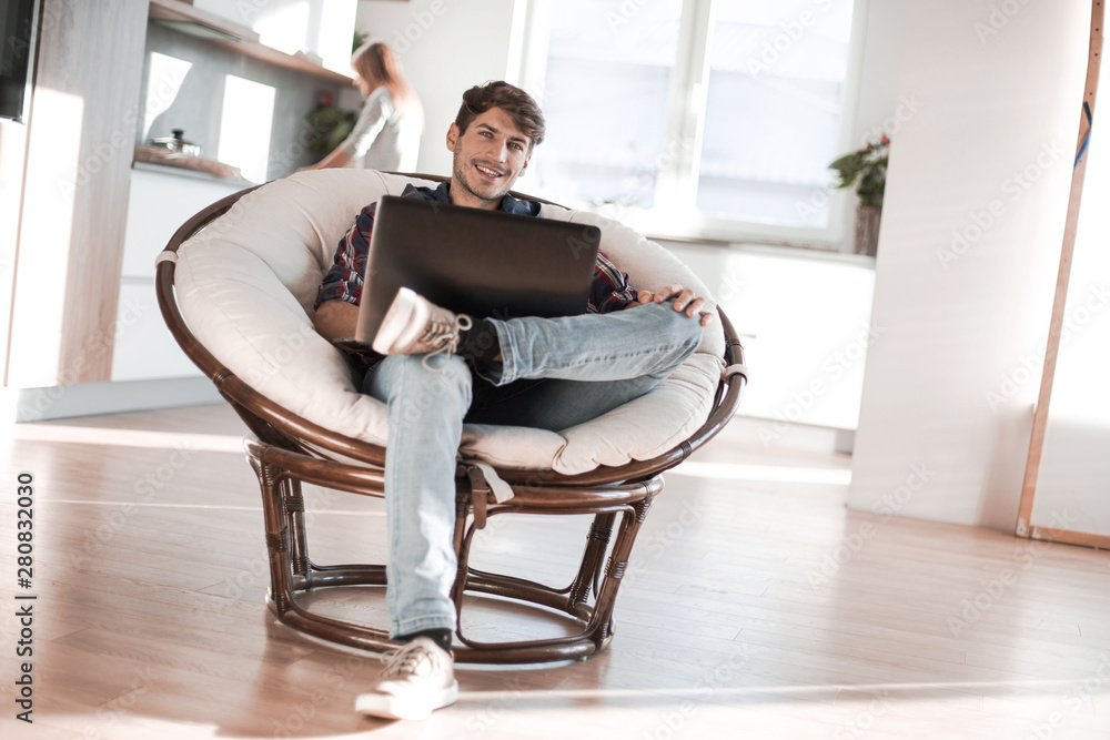 close up. tired guy dozing sitting in front of an open laptop